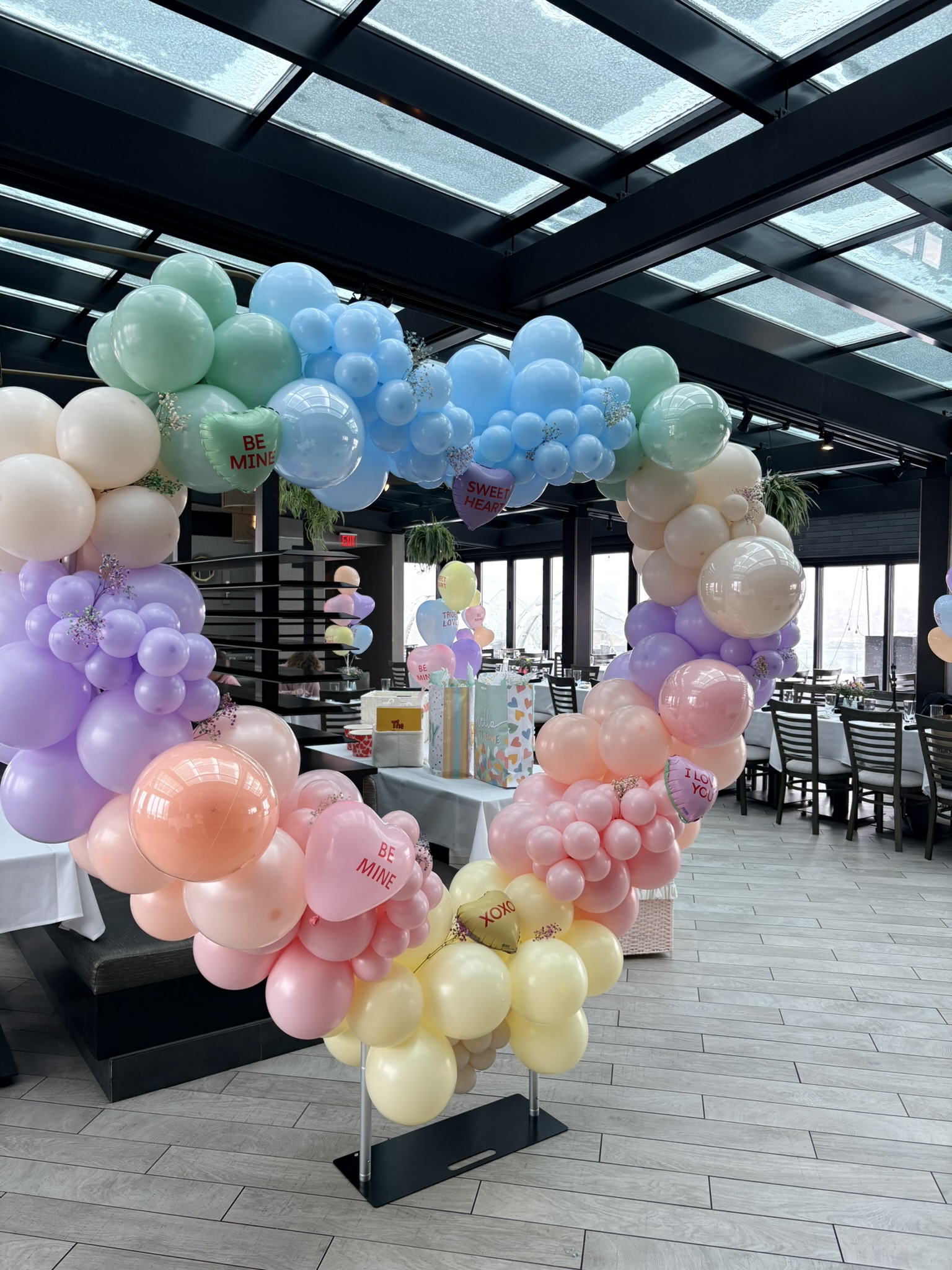 Six foot freestanding balloon installation focal point with conversation hearts Valentine's baby shower Rhode Island event
